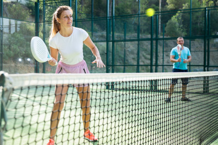 European woman padel tennis player trains on the outdoor courtの写真素材