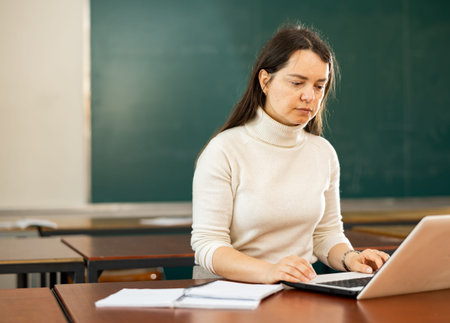 Portrait of a concentrated girl student preparing for classes