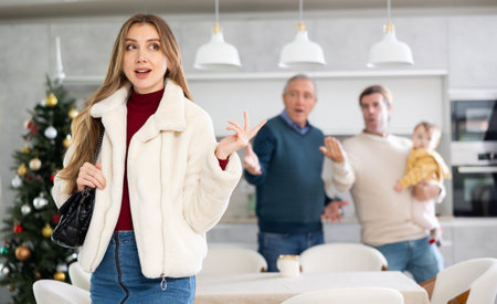 Two men quarreling with young womanの写真素材