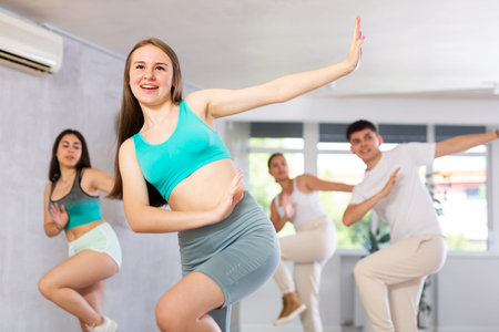 Boys and girls performing contemporary dance in studio