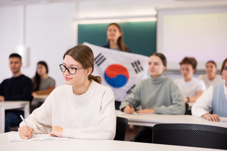 Young girl student diligently studies at schoolの写真素材