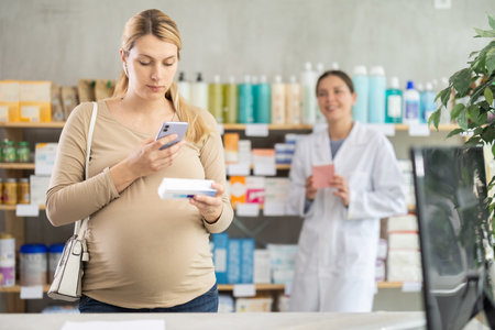 Pregnant woman buyer scans pills qr code with woman pharmacistの写真素材