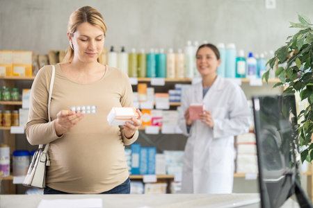 Pregnant woman choose supplements pills, pharmacist offer similar productの写真素材