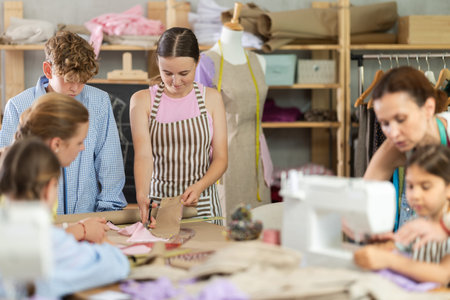 Children students cut fabric, work with material, preparatory work.