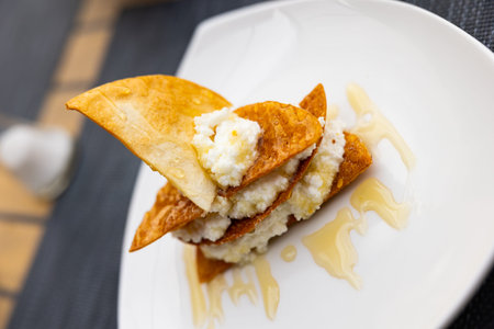 Portion of cottage cheese with sweet honey close up