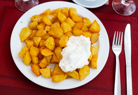 crispy fried potatoes served with sauceの写真素材