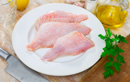 Raw chicken fillet on kitchen table