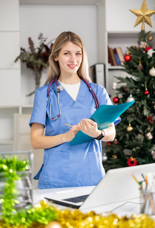 Nurse standing in office with clipboard during Christmasの写真素材