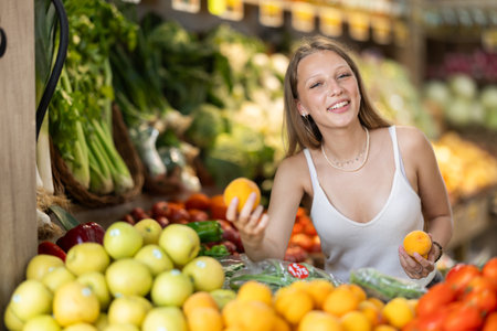 Blonde woman choosing peaches in the supermarketの写真素材