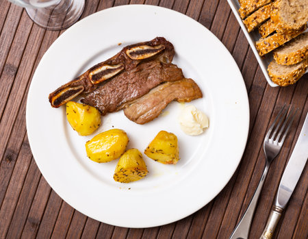 Grilled steak with potato served in a plateの写真素材