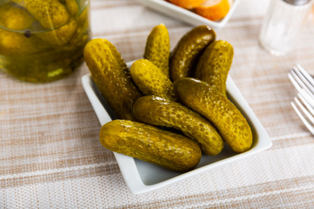 Pickled cucumbers on white plate, homemade preservesの写真素材
