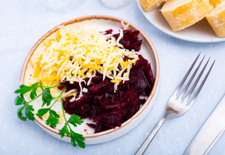 Vegan dish of boiled beetroot with tasty cheese, parsley and cream sauce on white plateの写真素材