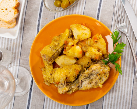 Baked chicken pieces with home-style stew potatoes for dinnerの写真素材