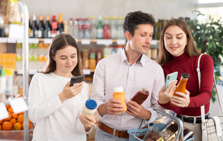 Family of buyers scans QR code on sauce packagingの写真素材