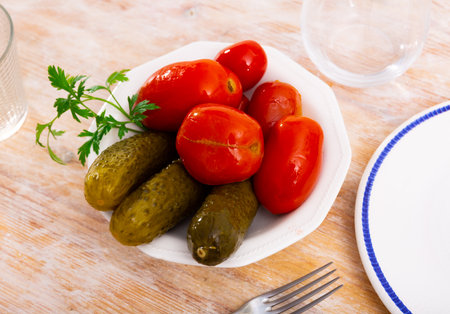 Homemade marinated tomatoes and cucumbers on plateの写真素材
