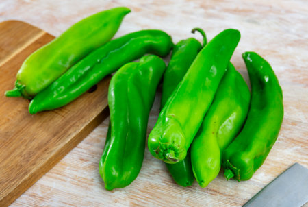 Green peppers on wooden table, cooking ingredientsの写真素材