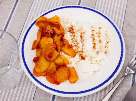 Delicious sliced sweet apple with cottage cheese served on plate for dessertの写真素材