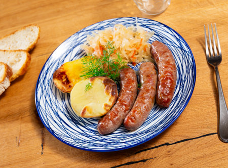Sausages served with potatoes and cabbageの写真素材