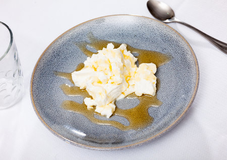 Portion of cottage cheese with sweet honey close upの写真素材