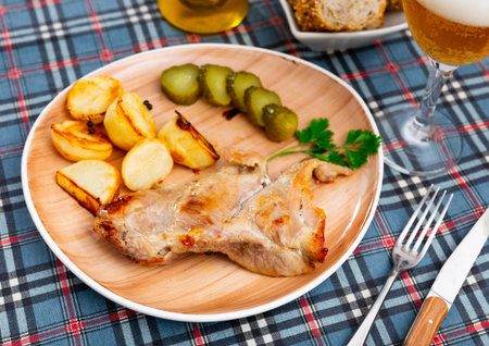 Tasty pork steak served with potatoes and pickles. Festive dinnerの写真素材