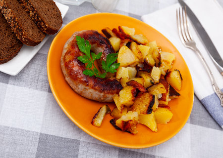 Grilled sausage garnished with potato prepared for dinnerの写真素材