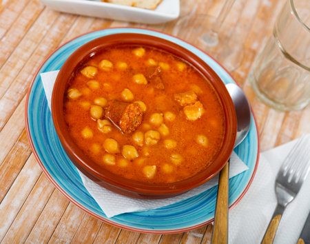 Chickpeas with chorizo served on plate in restaurantの写真素材