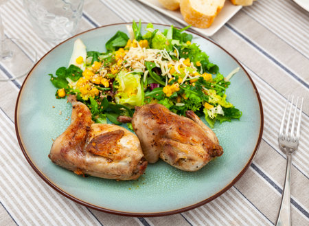 Fried quail served with vegetable saladの写真素材