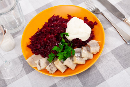 Traditional herring salad with beetroot and parsley in white plateの写真素材