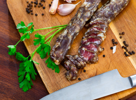Cured pork sausage with condiments on kitchen tableの写真素材