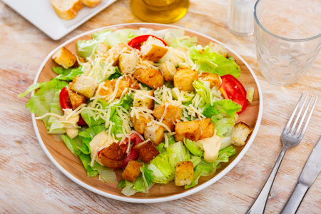 Portion of fresh Caesar salad with tomatoesの写真素材