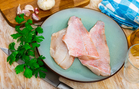 Raw chicken fillet on kitchen tableの写真素材