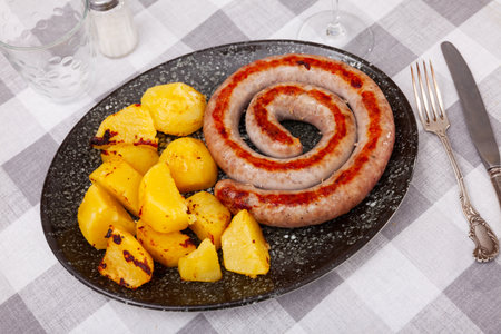 Grilled sausage garnished with potato prepared for dinnerの写真素材