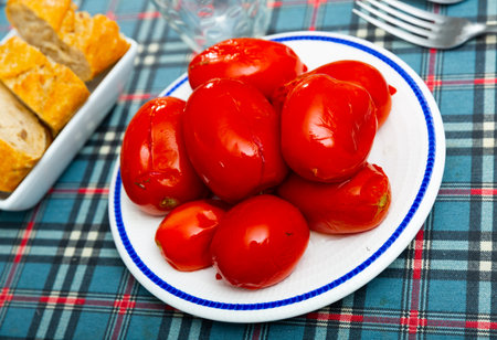 Vegetarian appetizer of homemade marinated tomatoes on plateの写真素材