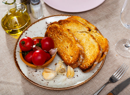 Sliced tomatoes on toasted breadの写真素材