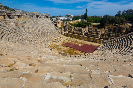 Remains of ancient theatre in Lycian settlement of Myra on background of Demre cityscapeの写真素材