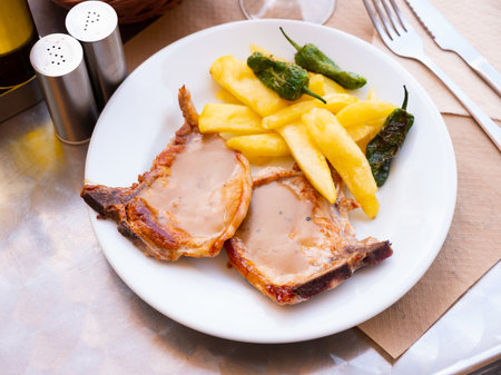 Pork steaks with fried potatoesの写真素材