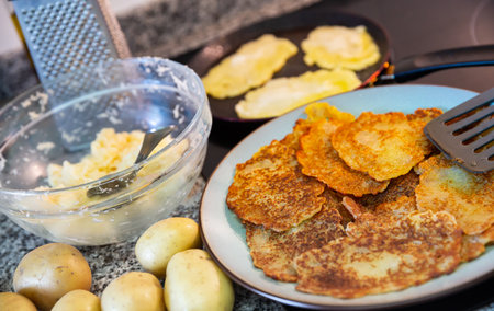 Preparation of potato pancakes on frying panの写真素材