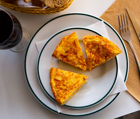 Appetizing tortilla with ham on white plateの写真素材