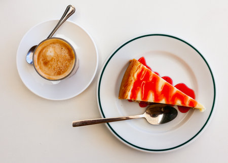 Slice of cheesecake Tarta de queso with strawberry jamの写真素材