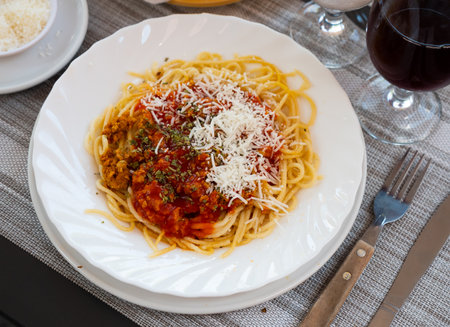 Spaghetti bolognese with grated Parmesan and aromatic dried herbsの写真素材