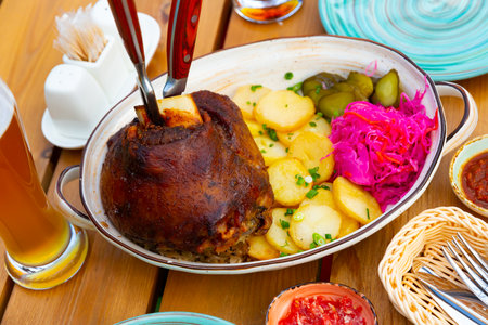 Roasted pork knuckle with potato and picklesの写真素材