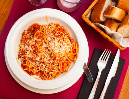 Italian bolonesa, bolognese noodles with tomato sauce and cheese in cafeの写真素材