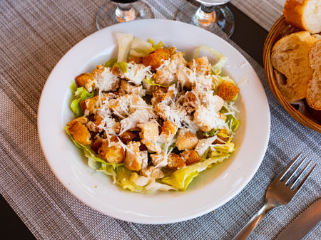 Chicken Caesar salad with tomatoes and cheeseの写真素材