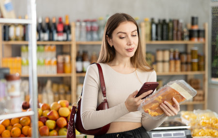 Young woman scanning qr code of chickenの写真素材
