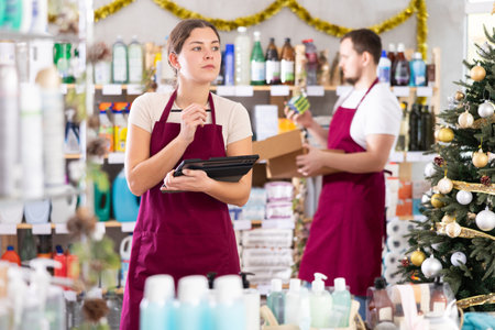 Female household goods store worker using tablet to manage inventoryの写真素材