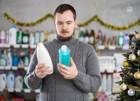 On New Year Eve, man choose and buy shampoo bottleの写真素材