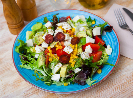 Catalonian salad with sausages, avocado and cheeseの写真素材