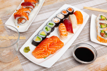 Variations of sashimi and sushi with soy sauce on tableの写真素材