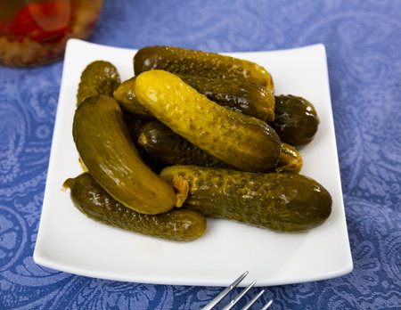 Pile of pickled cucumbers served on tableの写真素材