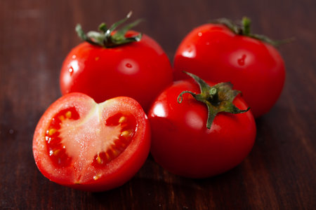 Whole and halved tomatoesの写真素材